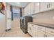 Functional laundry room with countertop, modern washer and dryer, and cabinetry at 9020 Tiffany Oaks Ave, Las Vegas, NV 89148