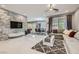 Open-concept living room with a stone accent wall, modern furnishings, and ample natural light at 9020 Tiffany Oaks Ave, Las Vegas, NV 89148