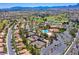 An aerial of community tennis courts, pool, landscaping, and surrounding neighborhood at 9912 Woodhouse Dr, Las Vegas, NV 89134