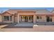 A covered back patio with a concrete area and a gravel landscape in a backyard at 9912 Woodhouse Dr, Las Vegas, NV 89134