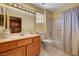 Bright bathroom with double sink vanity, tub-shower, tile flooring and large mirror at 9912 Woodhouse Dr, Las Vegas, NV 89134