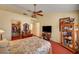 Bedroom featuring large bay window, ceiling fan and floral bedding at 9912 Woodhouse Dr, Las Vegas, NV 89134