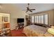 Bedroom featuring large bay window, ceiling fan and floral bedding at 9912 Woodhouse Dr, Las Vegas, NV 89134
