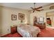 Bedroom featuring large bay window, ceiling fan and floral bedding at 9912 Woodhouse Dr, Las Vegas, NV 89134