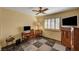 Bedroom with a desk and chair, a window with shutters and a ceiling fan at 9912 Woodhouse Dr, Las Vegas, NV 89134