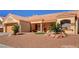 Single-story home with a desert-style yard featuring rock landscaping, desert plants and a terracotta roof at 9912 Woodhouse Dr, Las Vegas, NV 89134