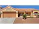 Charming single-story home showcasing a desert landscape, a terracotta roof, and double-door entrance at 9912 Woodhouse Dr, Las Vegas, NV 89134