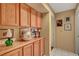 Hallway with built-in wood cabinets, decorative items and neutral color palette at 9912 Woodhouse Dr, Las Vegas, NV 89134