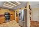 Kitchen with a stainless steel refrigerator, matching range, and tile floors at 9912 Woodhouse Dr, Las Vegas, NV 89134