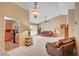 Bright living room featuring neutral paint, tile floors, vaulted ceiling and an open layout at 9912 Woodhouse Dr, Las Vegas, NV 89134