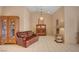 Bright living room featuring tile floors, neutral paint, vaulted ceilings, and vintage furnishings at 9912 Woodhouse Dr, Las Vegas, NV 89134