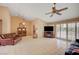Bright living room with tile floors, vaulted ceiling, ceiling fan, and sliding door access to the backyard at 9912 Woodhouse Dr, Las Vegas, NV 89134