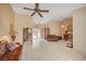 Bright and airy living room featuring tile floors, neutral paint, ceiling fan and vintage furnishings at 9912 Woodhouse Dr, Las Vegas, NV 89134