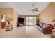 Bright living room featuring tile flooring, a ceiling fan, and sliding glass doors to let in natural light at 9912 Woodhouse Dr, Las Vegas, NV 89134