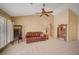 Bright living room featuring neutral paint, tile floors, vaulted ceiling, and comfortable seating at 9912 Woodhouse Dr, Las Vegas, NV 89134