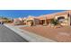 Inviting street view with desert landscaping, terracotta roofs, and houses in the neighborhood at 9912 Woodhouse Dr, Las Vegas, NV 89134