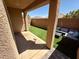 Cozy backyard with covered patio, artificial grass, and ample seating for relaxation at 10271 Headrick Dr, Las Vegas, NV 89166