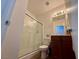 Bathroom featuring a sliding glass door shower, a dark wood vanity, and updated lighting at 10271 Headrick Dr, Las Vegas, NV 89166