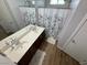 Bright bathroom with double vanity, framed mirrors, and shower with decorative curtains at 10271 Headrick Dr, Las Vegas, NV 89166