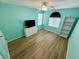 Bright bedroom with stylish decor, featuring a large window and light wood-look flooring at 10271 Headrick Dr, Las Vegas, NV 89166