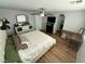 Well-lit primary bedroom with a large bed, wooden floor, ceiling fan and work desk at 10271 Headrick Dr, Las Vegas, NV 89166