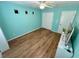 Bright bedroom featuring wood-look flooring, a large closet, and a stylish, modern aesthetic at 10271 Headrick Dr, Las Vegas, NV 89166