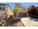 Two-story home showcasing desert landscaping, a two car garage, and a welcoming walkway to the front door at 10271 Headrick Dr, Las Vegas, NV 89166