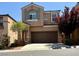 Two-story home featuring a well maintained yard, a two car garage, and charming architectural details at 10271 Headrick Dr, Las Vegas, NV 89166