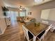 Open-concept living room with plank flooring, a large couch, and an adjacent dining area at 10271 Headrick Dr, Las Vegas, NV 89166