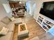 Spacious living area with plank flooring, a comfortable sectional sofa, and access to the kitchen and dining room at 10271 Headrick Dr, Las Vegas, NV 89166