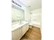 Clean bathroom featuring a shower-tub combination, ample vanity storage, and a large mirror at 10372 Beautiful Fruit St, Las Vegas, NV 89183