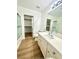 Bathroom featuring bright white cabinets, sink, and shower with sliding glass door at 10372 Beautiful Fruit St, Las Vegas, NV 89183