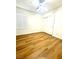 Bedroom with wood floors, fan, and double door closet at 10372 Beautiful Fruit St, Las Vegas, NV 89183