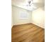 Light filled bedroom has hard wood floors and a ceiling fan at 10372 Beautiful Fruit St, Las Vegas, NV 89183