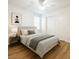 Comfortable bedroom has a neutral palette, ceiling fan, and wood-look flooring at 10372 Beautiful Fruit St, Las Vegas, NV 89183