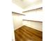 Walk-in closet with custom shelving and hardwood floors, ready for organization at 10372 Beautiful Fruit St, Las Vegas, NV 89183