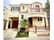 Inviting two-story home featuring a charming balcony, a two-car garage, and desert landscaping at 10372 Beautiful Fruit St, Las Vegas, NV 89183