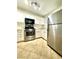 Bright kitchen with stainless steel appliances, white cabinets, and tile flooring at 10372 Beautiful Fruit St, Las Vegas, NV 89183