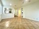 Spacious living room with tile flooring and archway to kitchen at 10372 Beautiful Fruit St, Las Vegas, NV 89183