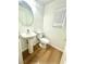 This powder room offers a pedestal sink, modern fixtures, and a window for natural light at 10372 Beautiful Fruit St, Las Vegas, NV 89183