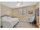 Cozy bedroom featuring a queen-sized bed, ceiling fan, and chair near window at 10409 Snowdon Flat Ct, Las Vegas, NV 89129