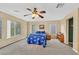 Large bedroom with ceiling fan and multiple windows offering natural light at 10409 Snowdon Flat Ct, Las Vegas, NV 89129