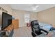 Inviting bedroom featuring a ceiling fan, natural light and ample space for work or leisure at 10409 Snowdon Flat Ct, Las Vegas, NV 89129