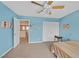 Cozy bedroom with a ceiling fan, closet, and light blue walls at 10409 Snowdon Flat Ct, Las Vegas, NV 89129