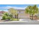 Two-story home with a well-kept lawn, a welcoming entrance, and a spacious driveway leading to the garage at 10409 Snowdon Flat Ct, Las Vegas, NV 89129