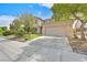 Charming two-story home features a well-manicured lawn, mature trees, and an attached two-car garage at 10409 Snowdon Flat Ct, Las Vegas, NV 89129