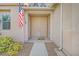 The double front door of this home is flanked by an American flag and flower bushes at 10409 Snowdon Flat Ct, Las Vegas, NV 89129