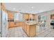 Bright eat-in kitchen boasts an island, ample counter space, and a sliding glass door leading outside at 10409 Snowdon Flat Ct, Las Vegas, NV 89129