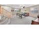 Comfortable upstairs living area featuring a billiard table, leather sofa, and staircase at 10409 Snowdon Flat Ct, Las Vegas, NV 89129