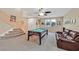 Upstairs living area features a billiard table, comfortable seating, and plenty of natural light at 10409 Snowdon Flat Ct, Las Vegas, NV 89129